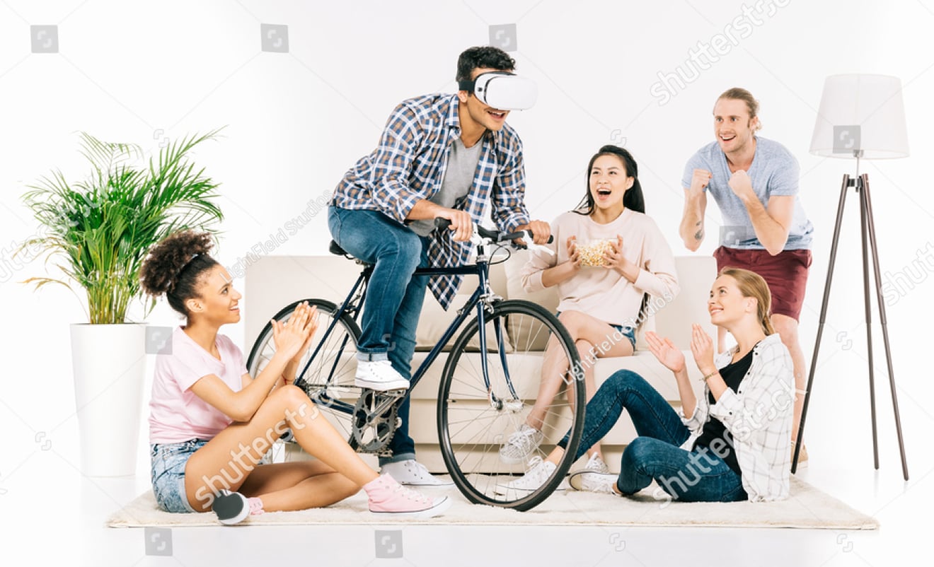 Man riding bicycle while wearing VR headset... in a living room